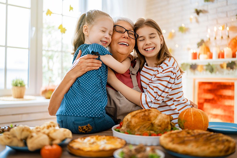 Grandmother hugging grandchilds during thanksgiving